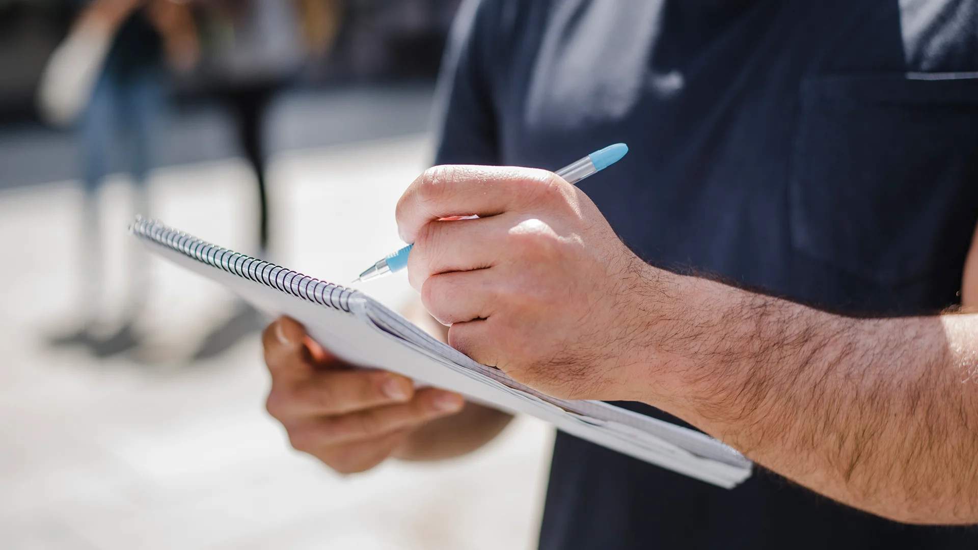 man-holding-notebook