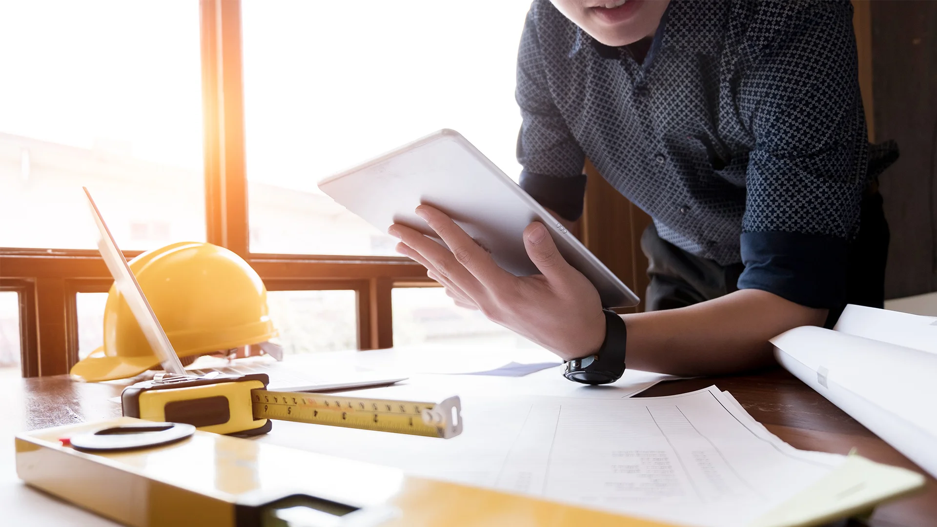 Midsection of engineer using digital tablet